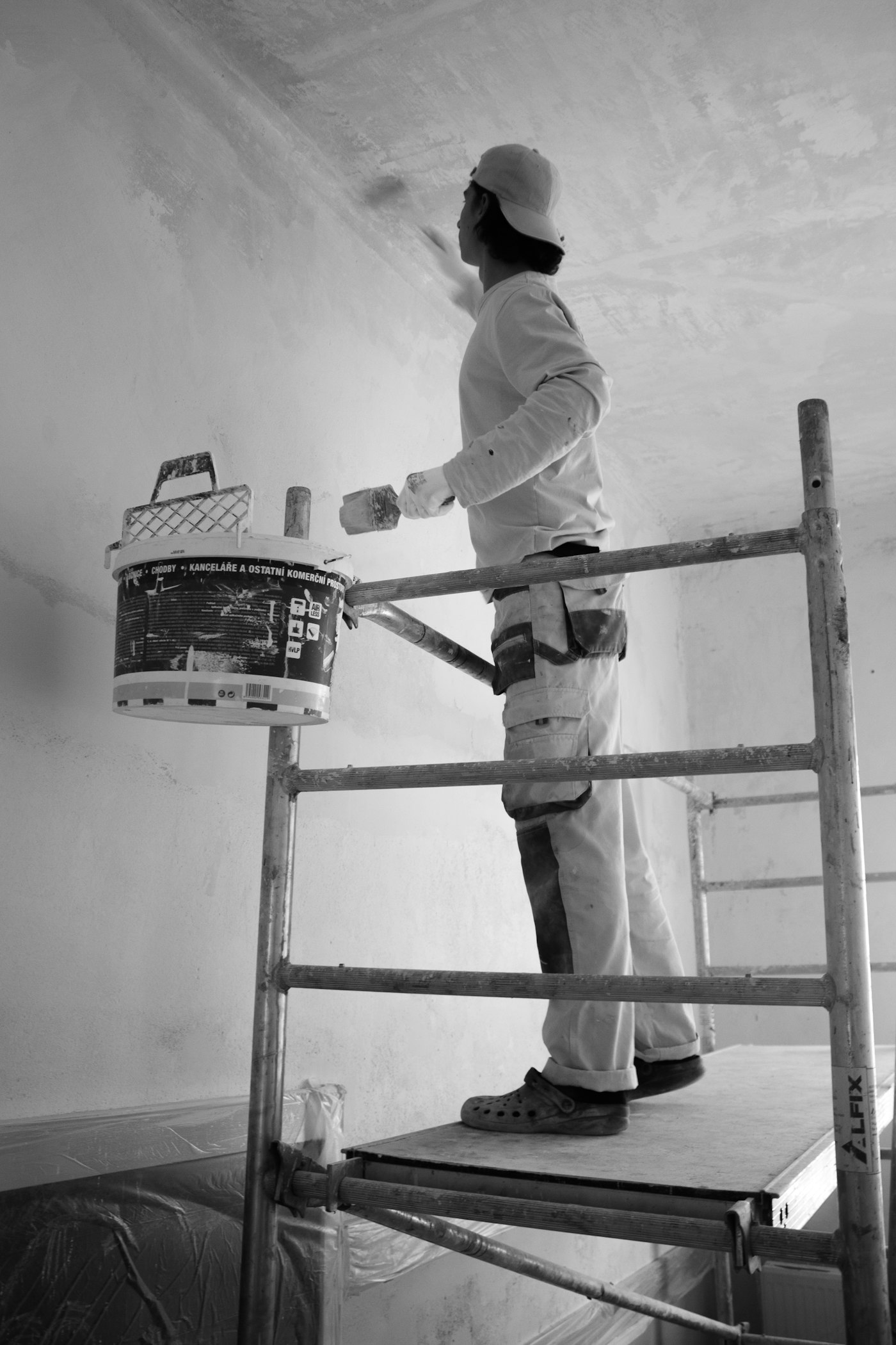 Painter working carefully on interior wall preparation