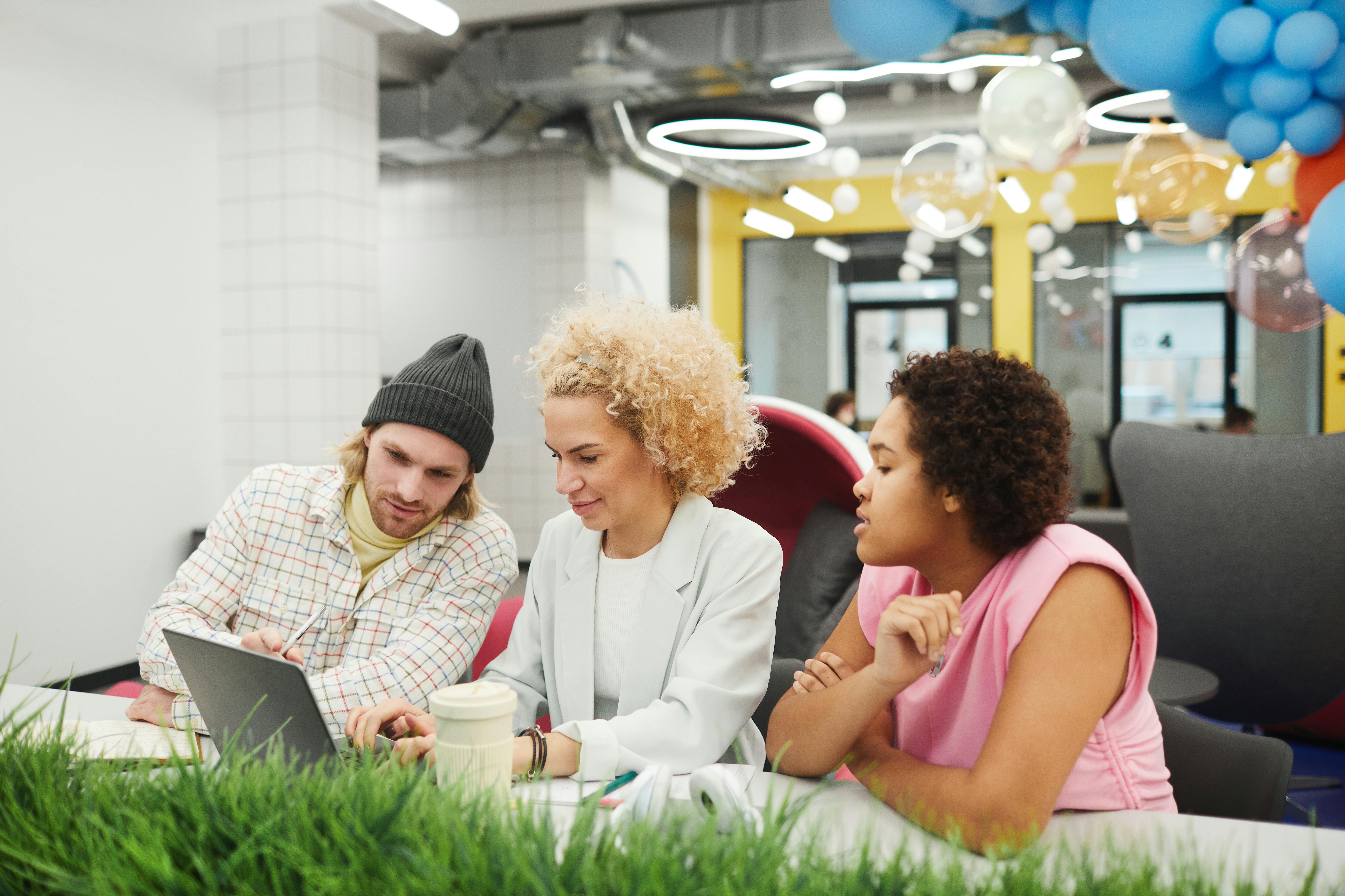 Three team members working together in an office