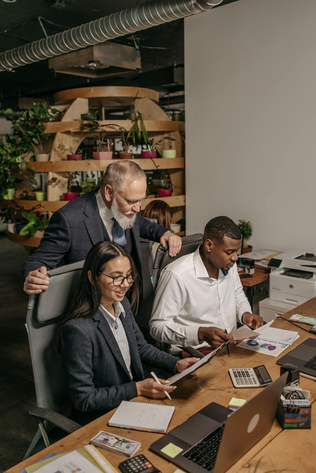 Three team members working together in an office